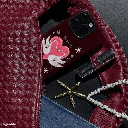 most protective iPhone 16 Pro case with a pretty illustration peeking out of a matching bag