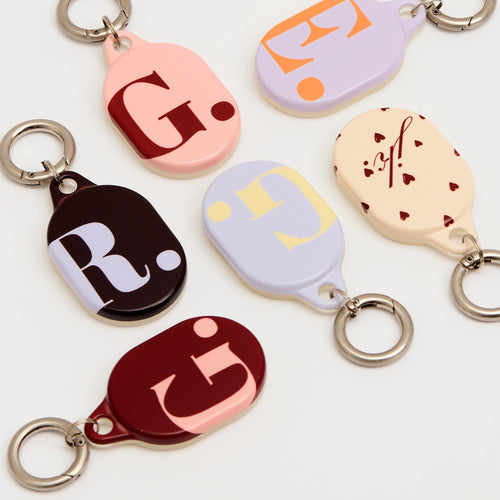 Personalized AirTags from The Dairy collection with custom designs for easy tracking and style